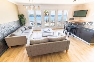 a living room with a couch and a table and a kitchen at Le Relais d'Agay in Agay - Saint Raphael