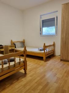 a small bedroom with a bed and a window at Summer house Kruce in Kruče