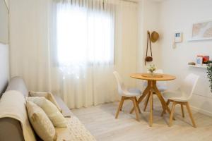 a living room with a couch and a table at TwinSuites Malaga in Málaga