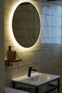 een badkamer met een wastafel en een spiegel bij ELISOS Studio Apartment with swimming pool in Vlorë