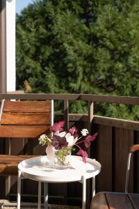 a table with a vase of flowers on a porch at Fewo Schneckenhalde App 18 in Bad Säckingen