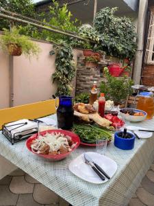 a table with a plate of food on it at Guesthouse Old Town in Kutaisi +28 photos