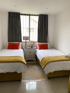 a bedroom with two beds and a window at Simla Luxury Apartments in Margate