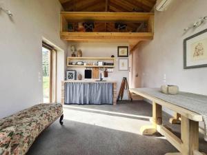 a living room with a table and a kitchen at Hidden gem of 1900, 7km from sea in Potamós