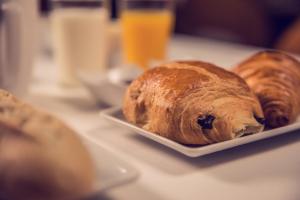 two croissants on a plate on a table at Timhotel Paris Gare Montparnasse in Paris