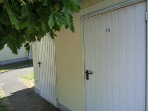 two white garage doors with the number on them at Ferienwohnung H 25 "Tausendschön" in Graal-Müritz