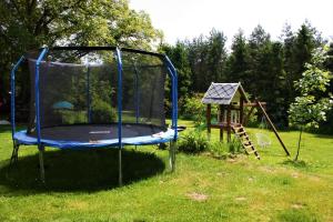 a playground with a trampoline and a playset at U Lesíčka in Vysoká