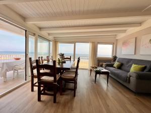 a living room with a table and a couch at Aria in Marina di Palma