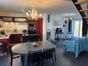 a kitchen and living room with a table and chairs at Kerhoki in Le Vivier-sur-Mer