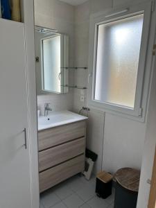 a white bathroom with a sink and a window at Kerhoki in Le Vivier-sur-Mer +7 photos