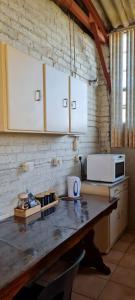 a kitchen with a counter top with a microwave at Green Thumb Farm Stay in Ermelo