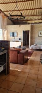 a living room with a couch and a bed at Green Thumb Farm Stay in Ermelo
