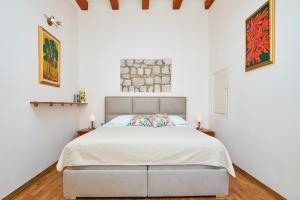 a bedroom with a bed in a room with white walls at Apartment Ermineous A34 in Dubrovnik
