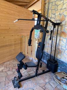 an exercise bike in a room with a stone wall at B&B Belvedere in Presa