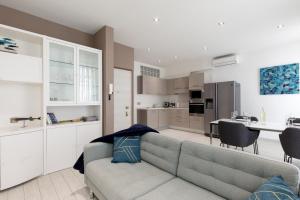 a living room with a couch and a kitchen at beautiful 3 room-flat near palais in Cannes