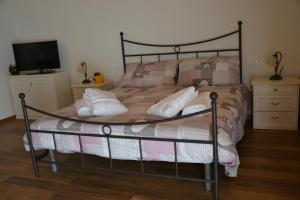 a bed with a metal frame and pillows on it at Agriturismo Gradec in Aurisina
