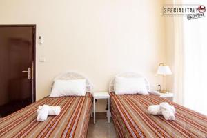 two beds sitting next to each other in a room at Mary's Guest House in Bethlehem