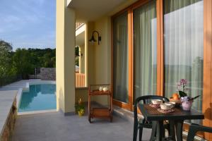 a patio with a table and a pool at Agriturismo Gradec in Aurisina