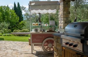 a outdoor grill with a food cart under an umbrella at Terre di Baccio in Greve in Chianti