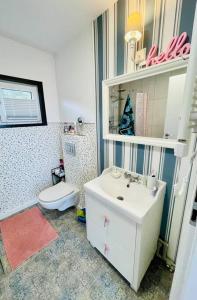 a bathroom with a white sink and a toilet at PAPIERÓWKA in Dźwierzuty