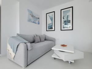 a living room with a couch and a table at Iliada Studio Oxygen Neptun in Neptun