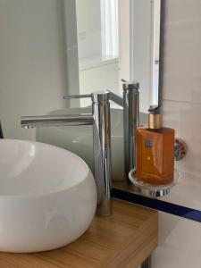 a bathroom with a white sink and a mirror at Iliada Studio Oxygen Neptun in Neptun