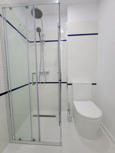 a bathroom with a toilet and a glass shower at Iliada Studio Oxygen Neptun in Neptun +8 photos