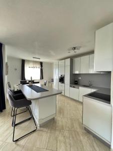een grote keuken met witte kasten en een aanrecht bij Apartments Ursula 3 in Trogir