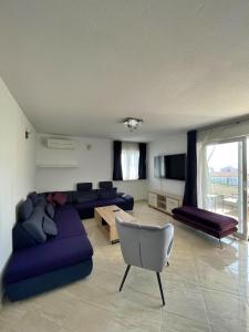 een grote woonkamer met een bank en een tafel bij Apartments Ursula 3 in Trogir