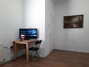 a computer monitor sitting on a desk in a room at Llewellyn House in Llwyn-y-pia