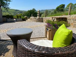 a patio with a table and a table and chairs at The View, Luxury studio in Curbar