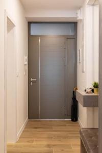 a hallway with a door in a room with wood floors at Flat4us#cozy#freeparking#5people in Zagreb
