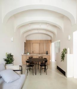 a kitchen and dining room with a table and chairs at Trabuxu Boutique Living in Valletta