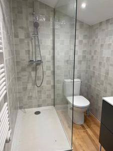 a bathroom with a shower and a toilet at Charmante maison aux Abatilles-piscine-8 pers in Arcachon