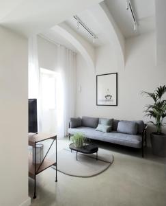 a living room with a couch and a table at Trabuxu Boutique Living in Valletta