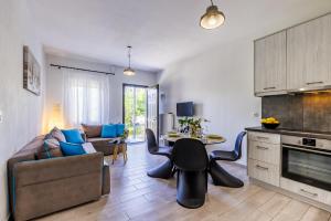 a living room with a couch and a table at The Green Yard Apartment in Skopelos Town