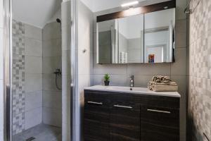 a bathroom with a sink and a shower at The Green Yard Apartment in Skopelos Town