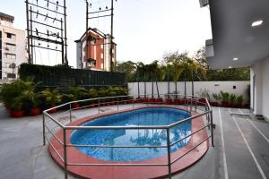 a swimming pool on the roof of a building at Click White House Residency, Vadodara in Vadodara
