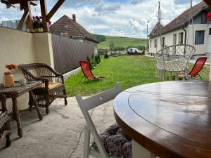 Casa Cheilor في Petreştii de Jos: طاولة وكراسي في الفناء الخلفي للمنزل