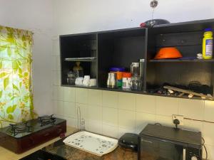 a kitchen with a stove and a counter top at Harmonious haven services in Ibadan