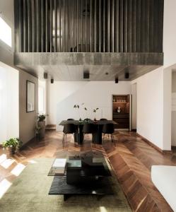 a dining room with a black table and black chairs at Trabuxu Boutique Living in Valletta