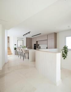 a kitchen with white counters and a white counter top at Trabuxu Boutique Living in Valletta