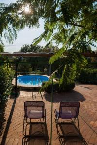 two chairs sitting next to a swimming pool at House Polic in Hreljin