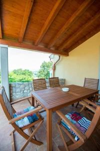 a wooden dining table and chairs in a room at House Polic in Hreljin