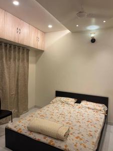 a bedroom with a large bed with avertisement at Myra's house in Kolhapur
