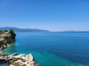 een uitzicht op een waterlichaam met een strand bij ELISOS Studio Apartment with swimming pool in Vlorë