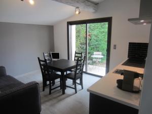 a kitchen and living room with a table and chairs at Apartement Les Alpilles in Eygalières