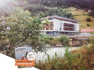 un gran edificio blanco en una colina con una casa en Mountain Life, en Kappl