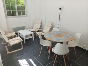 a waiting room with a table and chairs at O'Couvent - Appartement 513 - 2 chambres - 62 m2 - Premier étage in Salins-les-Bains