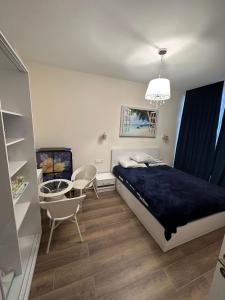 a bedroom with a bed and a table and chairs at Family Inn in Gonio